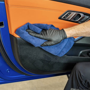AMMO microfiber towel being used to clean a car