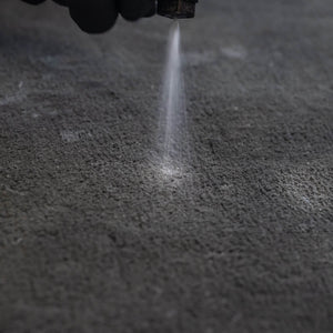 AMMO DYGEST being applied to a pet stain in a car interior