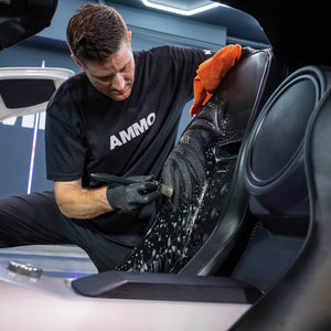 AMMO Interior Brush being used to clean a car interior