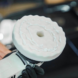 AMMO WÄFL finishing pad attached to a dual action polisher